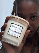 Load image into Gallery viewer, Woman holding a Cherry Vanilla candle by Wax On Vine close to her face
