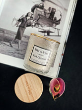 Load image into Gallery viewer, Elegant Wax On Vine Red Currant candle beside flower and wooden lid