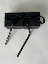 Load image into Gallery viewer, Black gift box with ribbon containing three travel-sized scented candles